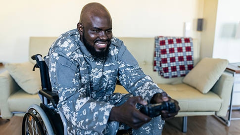 Man in wheelchair and playing video games