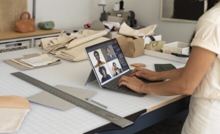 Image for: Contextual photography of adult female inside using Surface Pro X to participate in Microsoft Teams call.