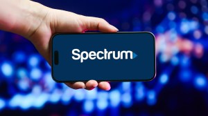 hand holding phone with Spectrum logo on screen
