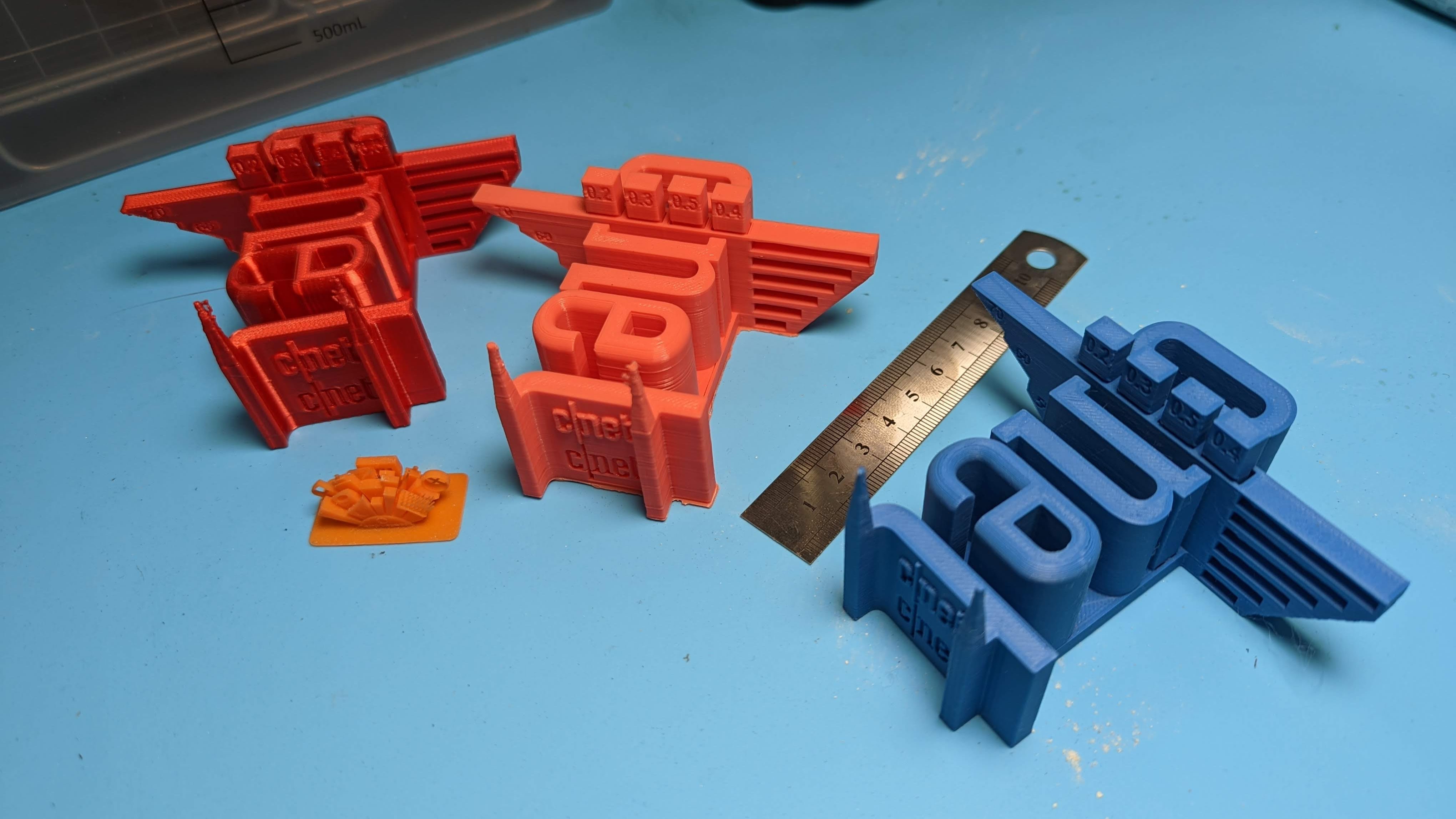Four 3D-printed models that show errors from 3D printing