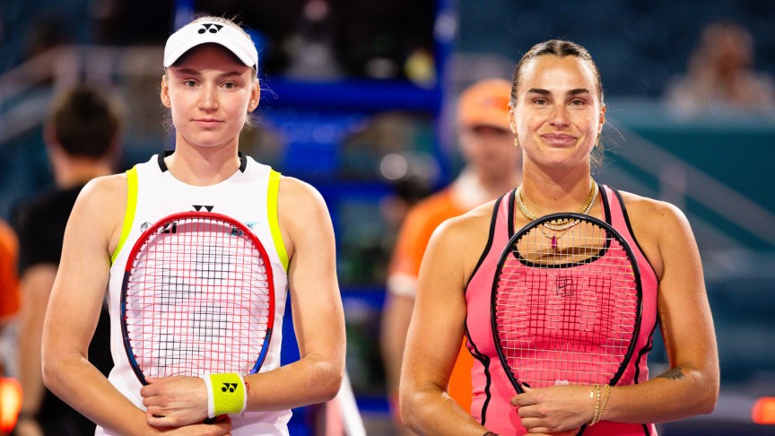 Elena Rybakina and Aryna Sabalenka posing for a picture while both holding tennis raquets.