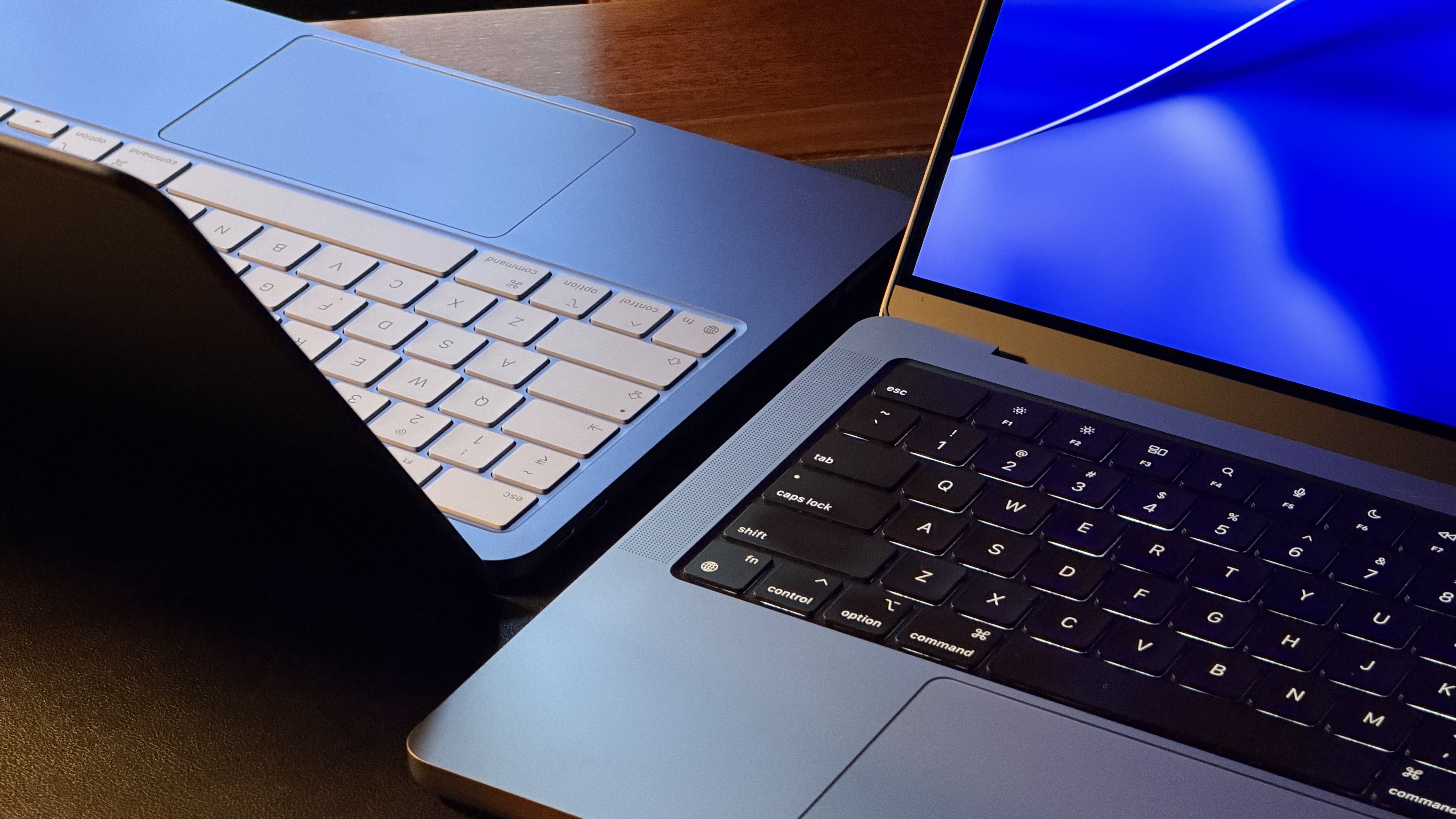 MacBook Neo and MacBook Pro kept next to each other on a table