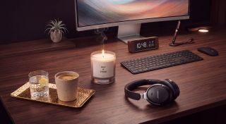 A selection of luxurious desk items on a dark wood desk