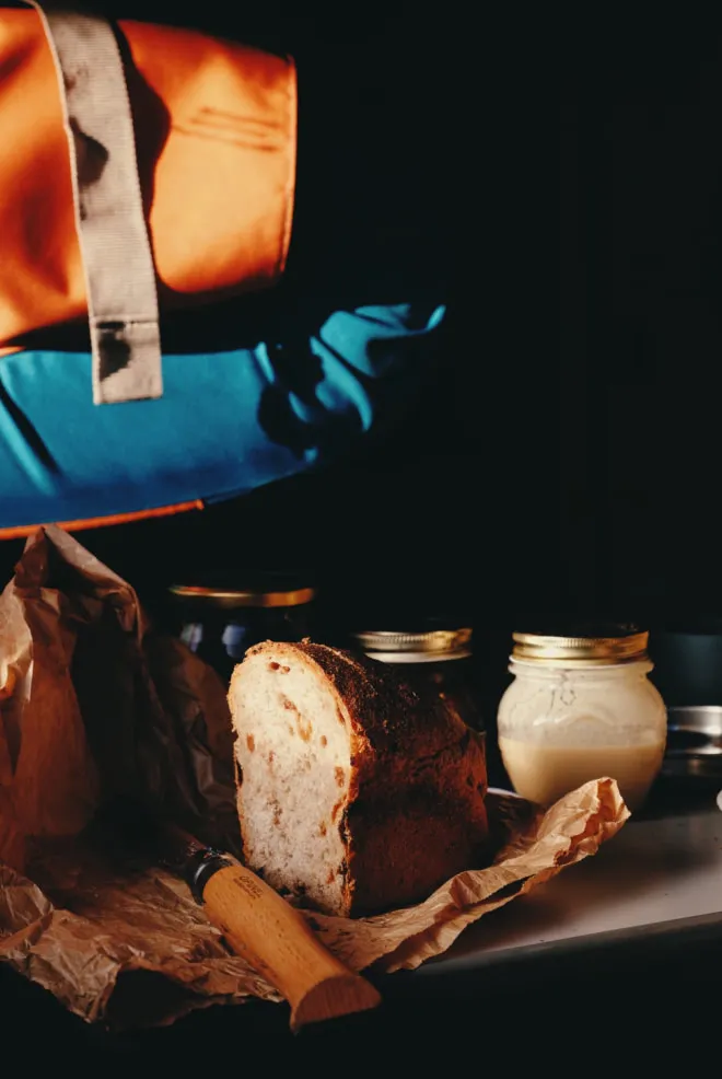 Rustic bread with a knife and almond butter in mason jars edited on VSCO with KA1 filter by photographer Simone Enei