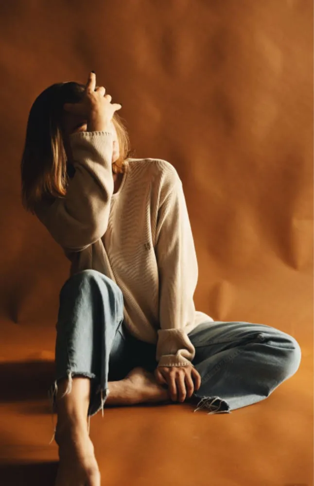 Portrait of a woman sitting down and covering her face by professional photographer Sasha Stepanyuk