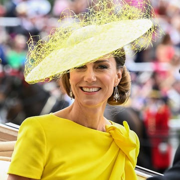woman in a bright yellow dress with a large yellow hat woman in a bright yellow dress with a large yellow hat