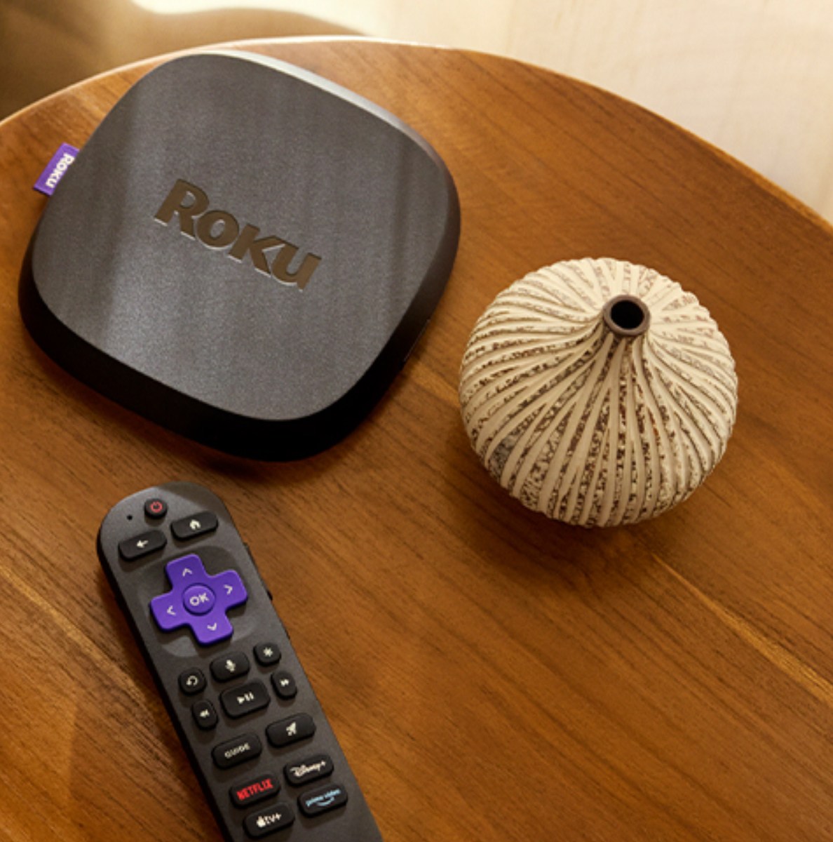 Roku's Ultra streaming box and remote on top of a table.
