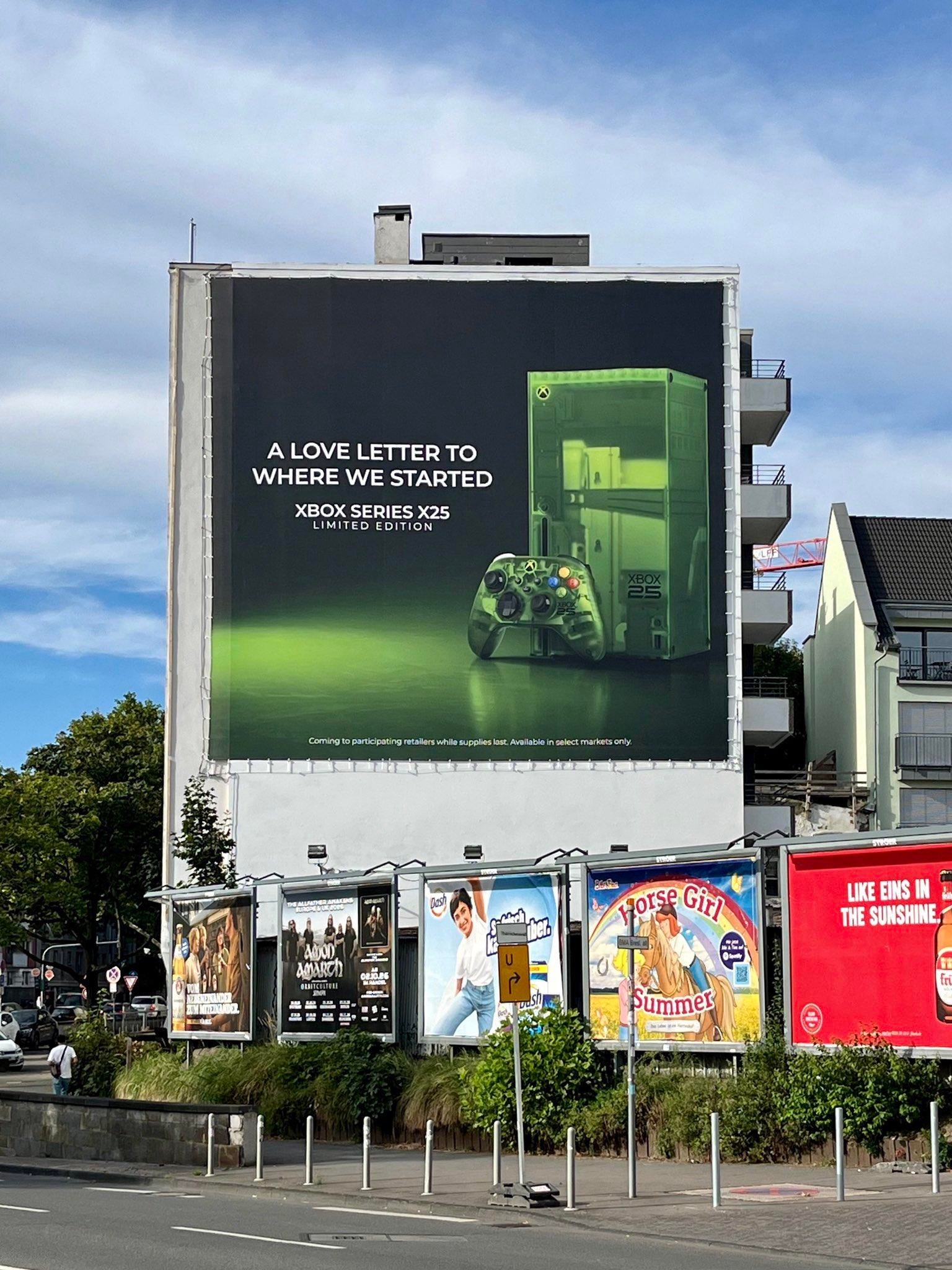 A photo of a billboard in Cologne, showing the 25th anniversary Xbox.