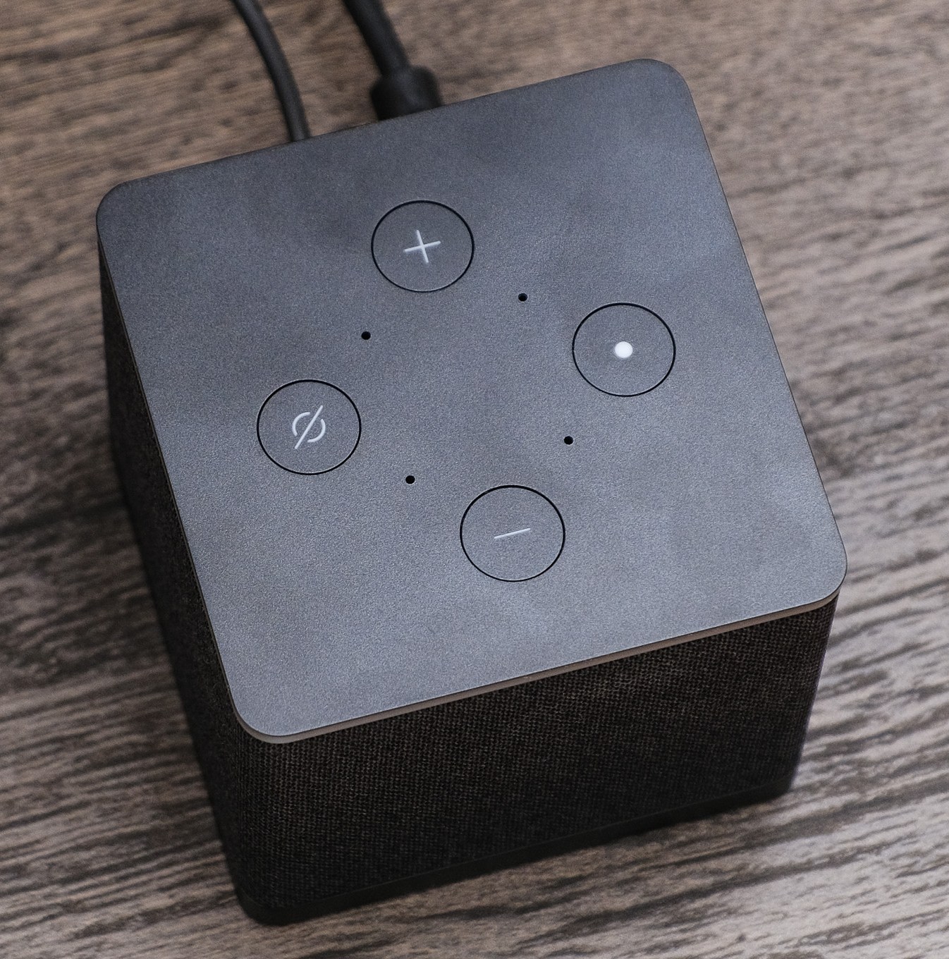 A photo of Amazon’s Fire TV Cube on a TV stand.