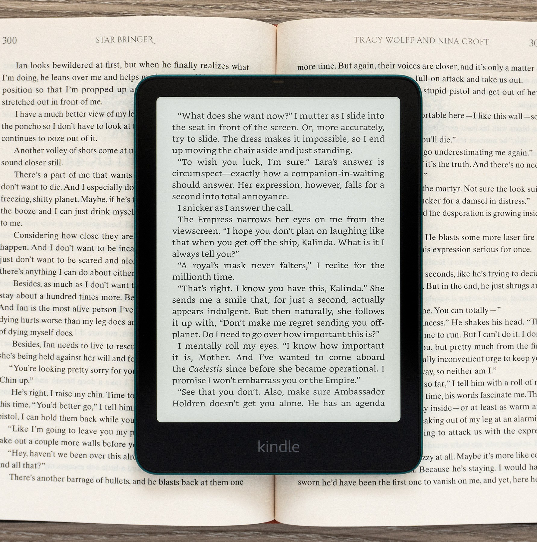 The Amazon Kindle Paperwhite Signature Edition (2024) displaying a page of text sitting on an open book.